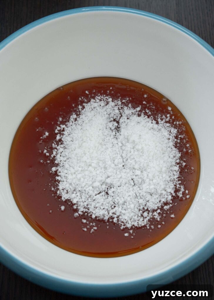 Quick 10-Minute Homemade Gochujang Recipe 8 Korean rice syrup and coarse salt combined in a mixing bowl.