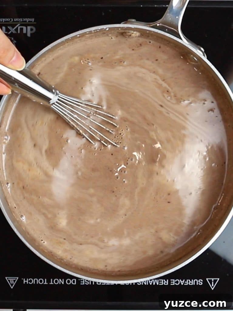 Decadent Homemade Hot Chocolate Recipe — Rich, Creamy & Velvety 13 whisking hot chocolate in a pot