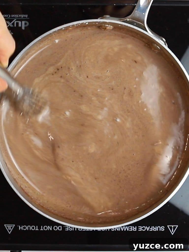Decadent Homemade Hot Chocolate Recipe — Rich, Creamy & Velvety 14 whisking hot chocolate in a pot