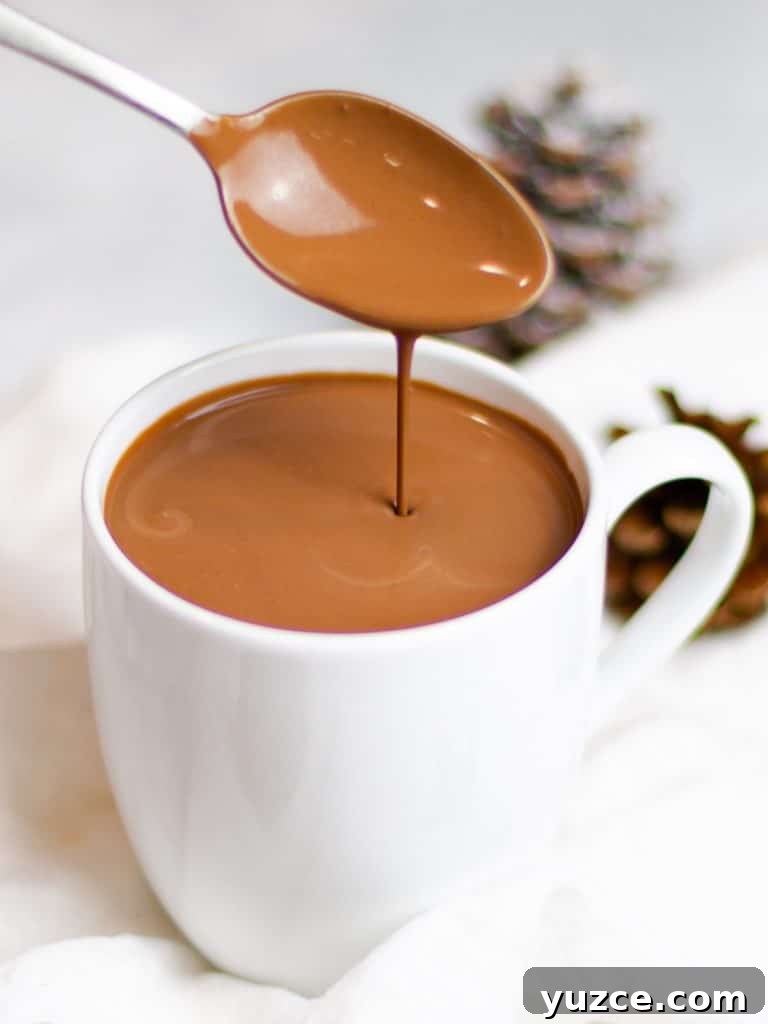 Decadent Homemade Hot Chocolate Recipe — Rich, Creamy & Velvety 5 rich and creamy homemade hot chocolate dripping off a spoon