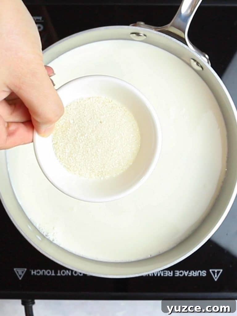Decadent Homemade Hot Chocolate Recipe — Rich, Creamy & Velvety 9 sugar in a small bowl with a pot of milk