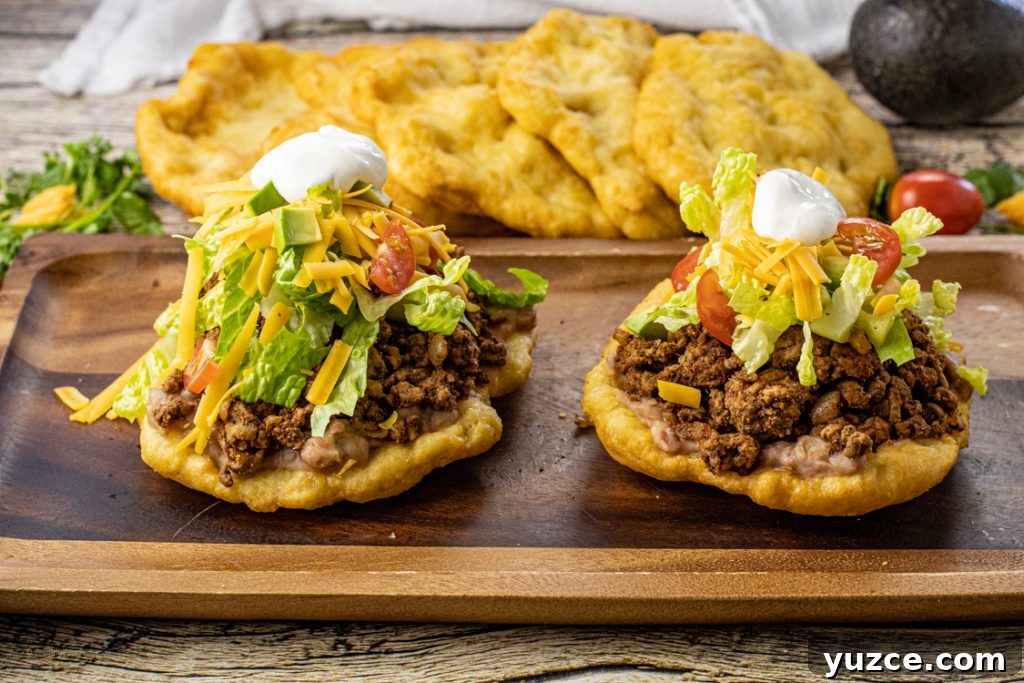 Fry Bread Tacos: Classic Family Dinner Recipe 3 scones topped with taco meat, lettuce, cheese, tomatoes and sour cream