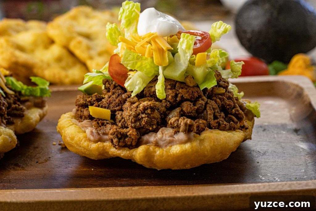Fry Bread Tacos: Classic Family Dinner Recipe 4 scones topped with taco meat, lettuce, cheese, tomatoes and sour cream
