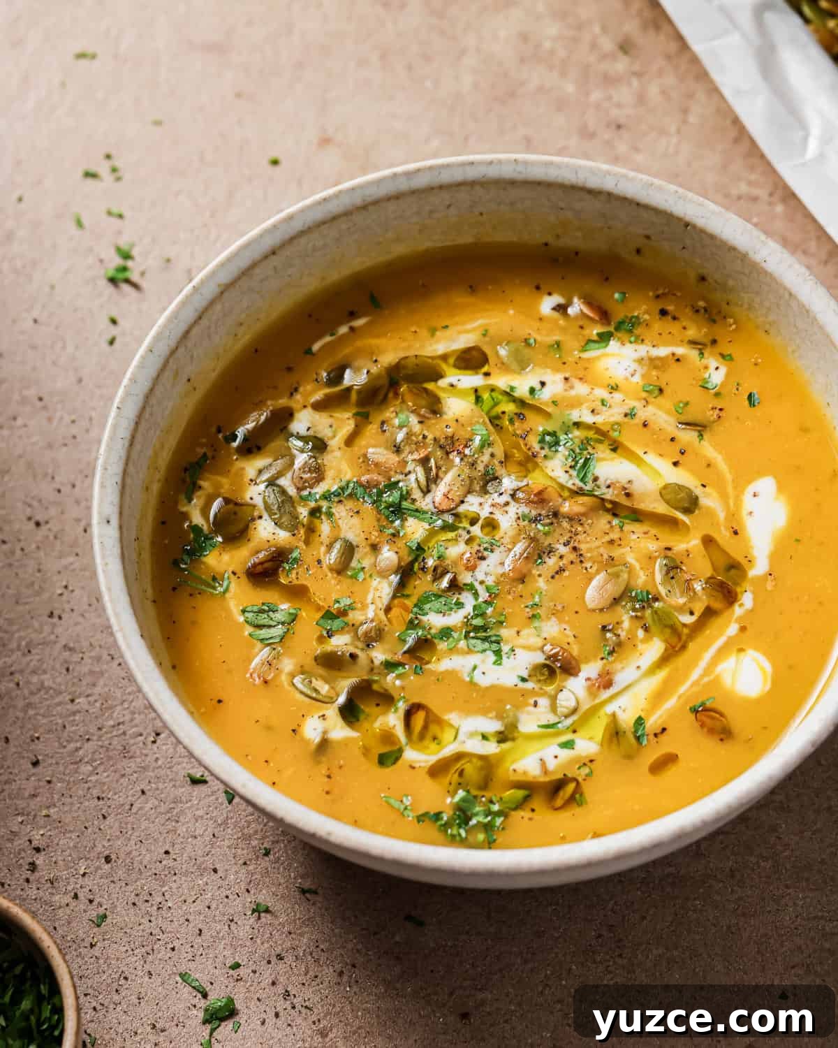 Crispy Oven-Roasted Pepitas with Sea Salt 12 bowl of soup topped with roasted pepitas.