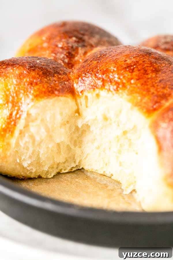 Crispy Air Fryer Dinner Rolls Recipe for Soft, Fluffy Buns 8 Stack of air fryer dinner rolls showing soft crumb.