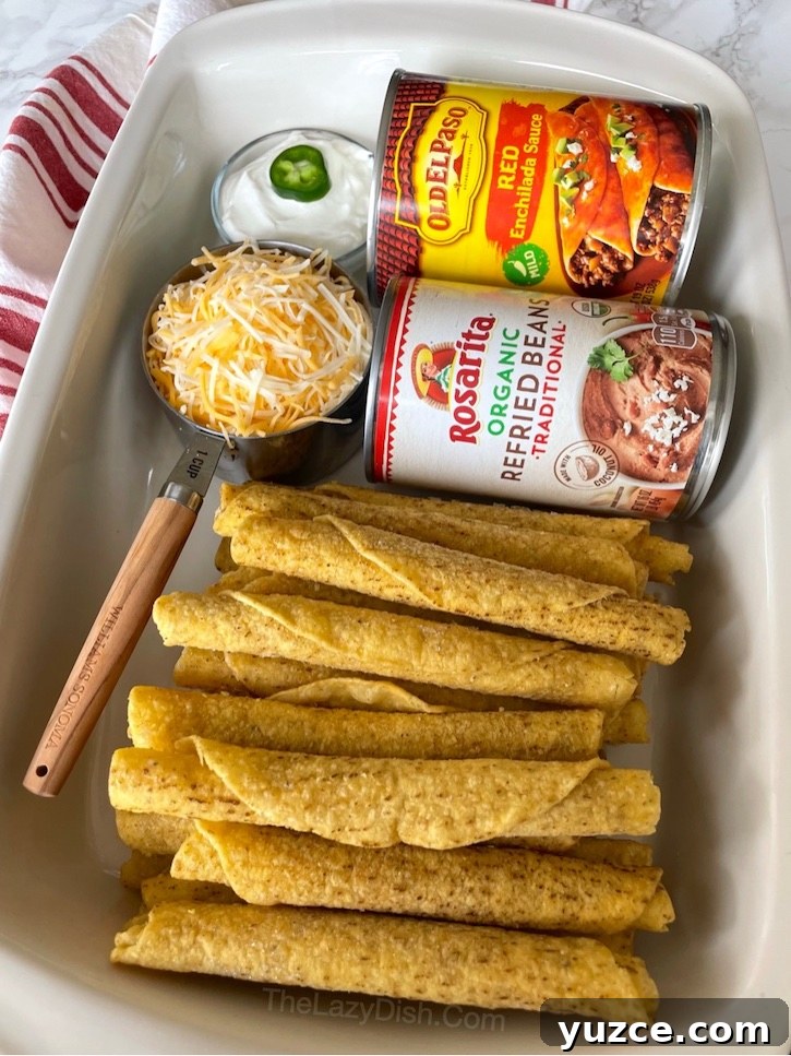 Quick Frozen Taquito Enchiladas: 30-Minute Weeknight Recipe 4 Frozen Taquito Dinner Casserole | This is basically a lazy way of making enchiladas! It's so easy, anyone can make it, yet it tastes like something you'd get at a fancy Mexican restaurant. Just 4 cheap ingredients for this simple meal: frozen taquitos (chicken or beef), enchilada sauce, refried beans, and cheese. So yummy! My picky eaters love it.