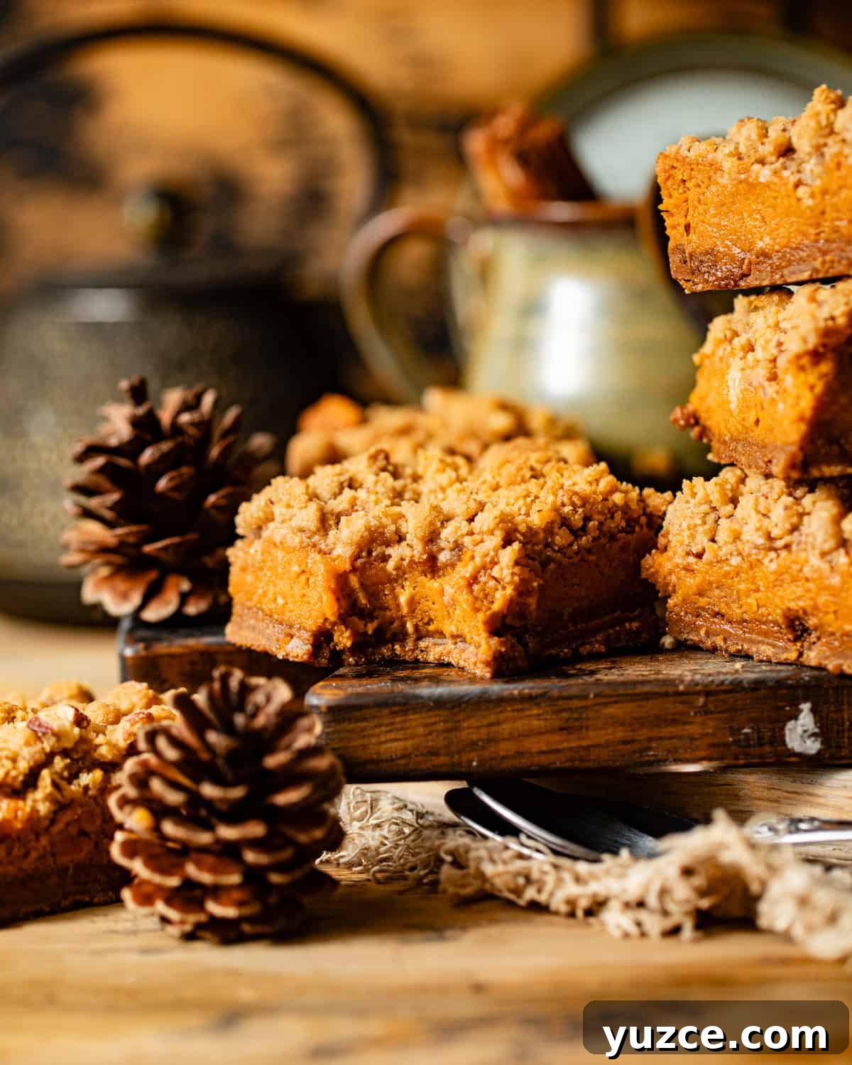 sweet potato pie bars on a cutting board with a bite taken out of it.