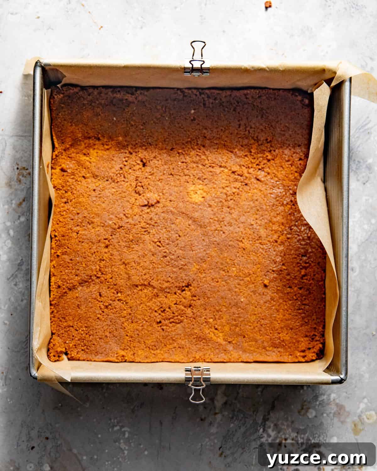 biscoff cookie crust pressed into a single layer in a 9 inch baking pan.
