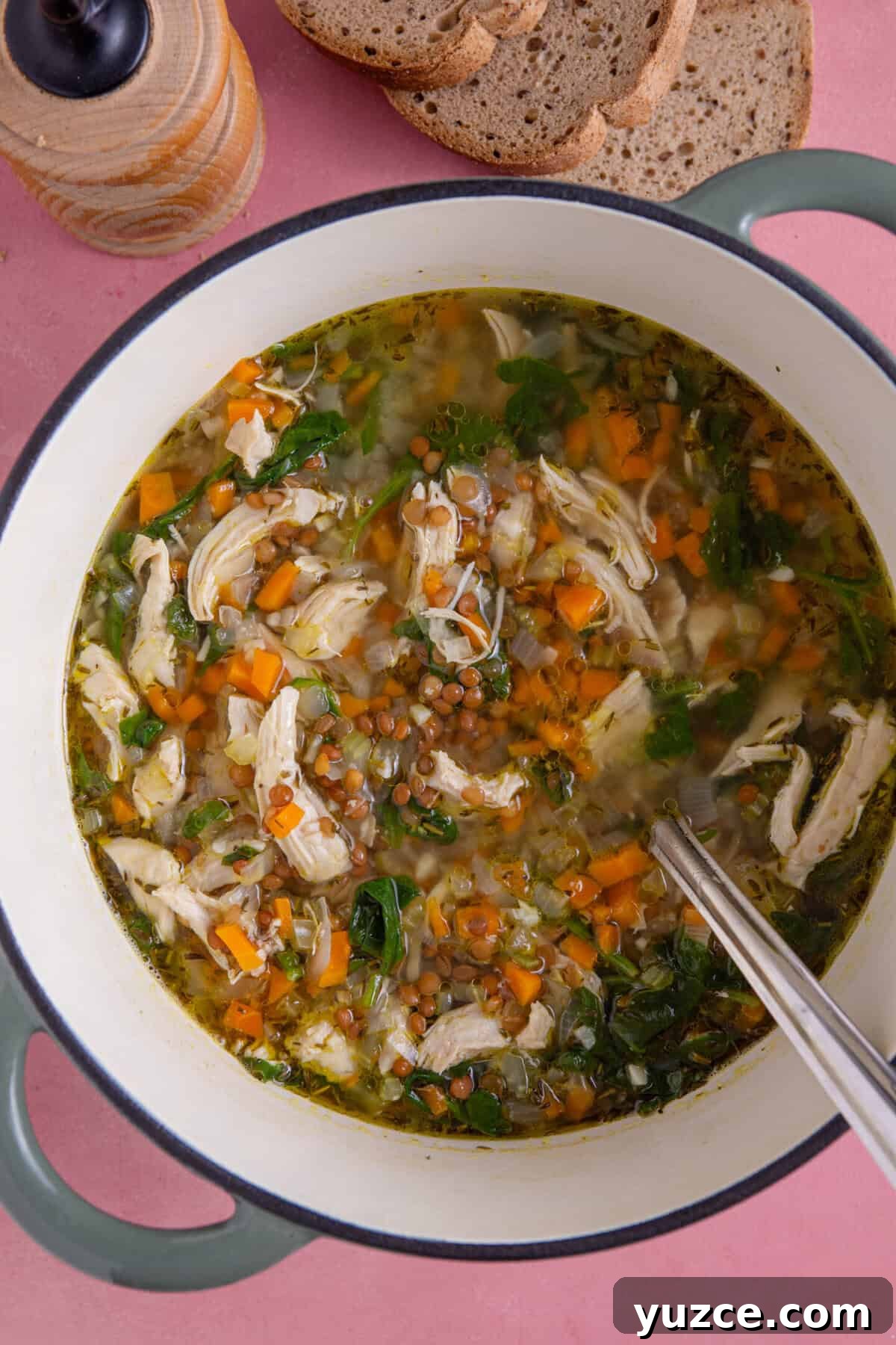Hearty Chicken and Lentil Soup Recipe for Cozy Weeknights 2 A pan of chicken and lentil soup with a side of gluten free bread.