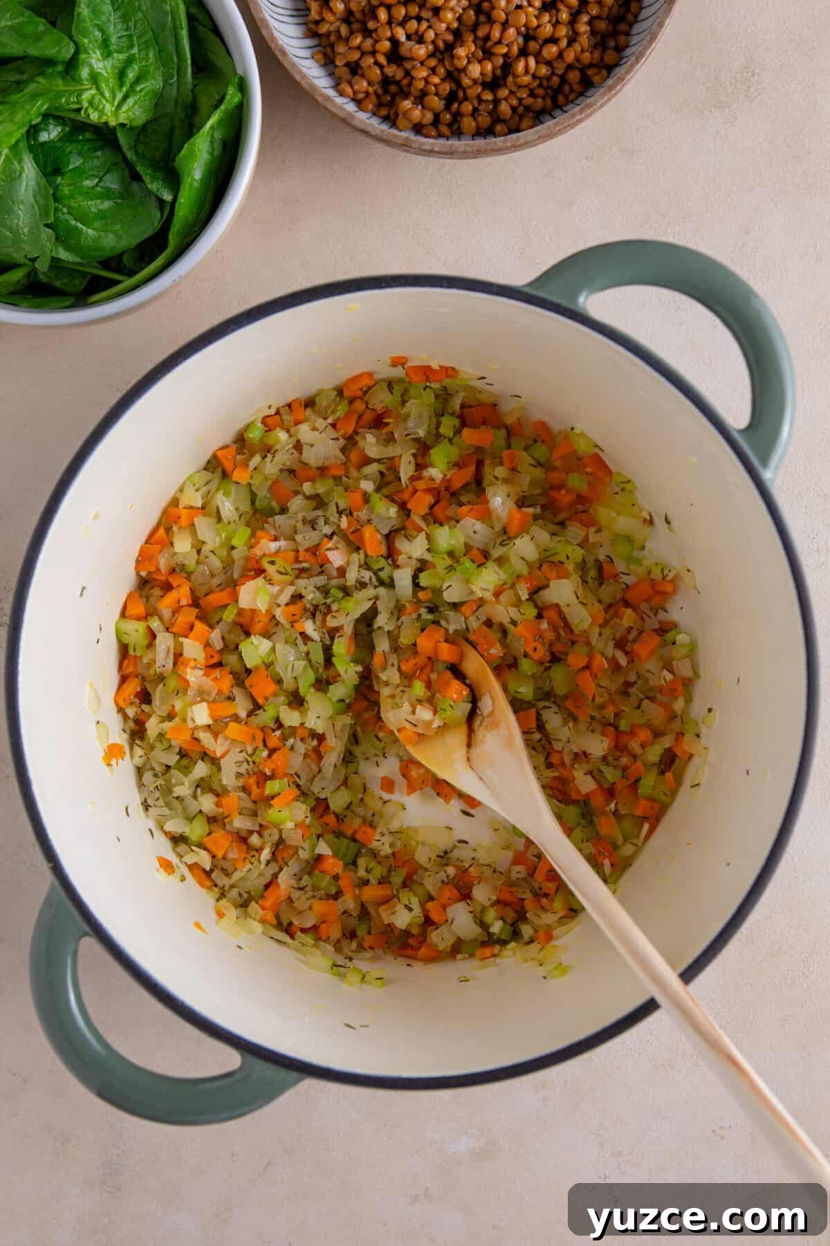 Hearty Chicken and Lentil Soup Recipe for Cozy Weeknights 5 A process shot of chicken and lentil soup making showing the vegetable base cooked down in a pan.