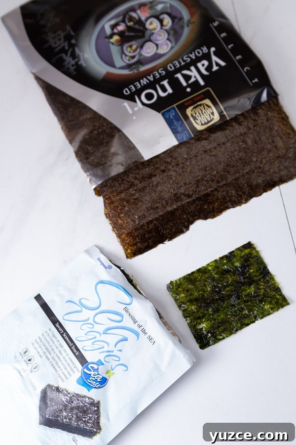 Grilled Salmon Bowl with Quinoa, Avocado & Citrus Dressing 9 small seaweed snacks in the lower left, and a full sized nori sheet in the upper part of the photo.
