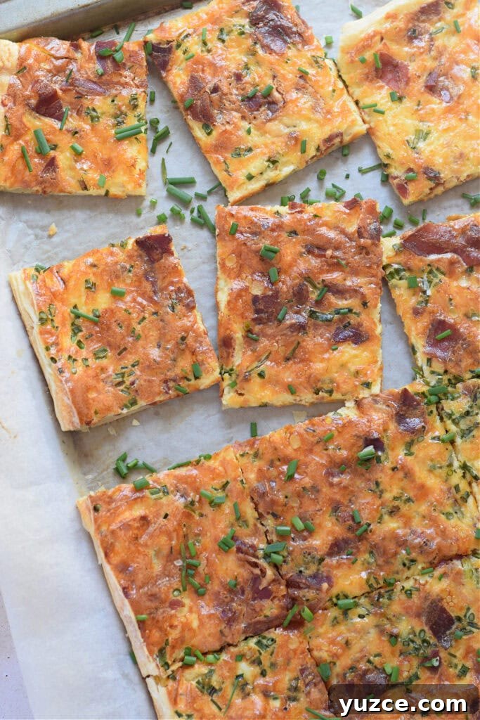 Flaky Puff Pastry Breakfast Quiche with Spinach and Cheese 11 Sheet pan quiche cut into squares.