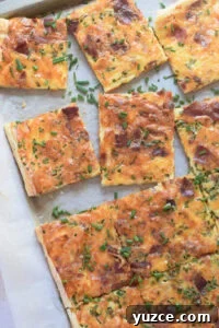 Flaky Puff Pastry Breakfast Quiche with Spinach and Cheese 17 Puff pastry quiche on a baking tray.