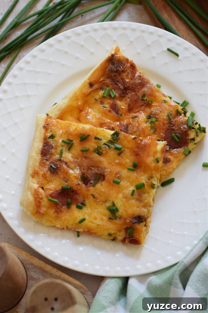 Flaky Puff Pastry Breakfast Quiche with Spinach and Cheese 4 Close up of puff pastry breakfast quiche on a plate.