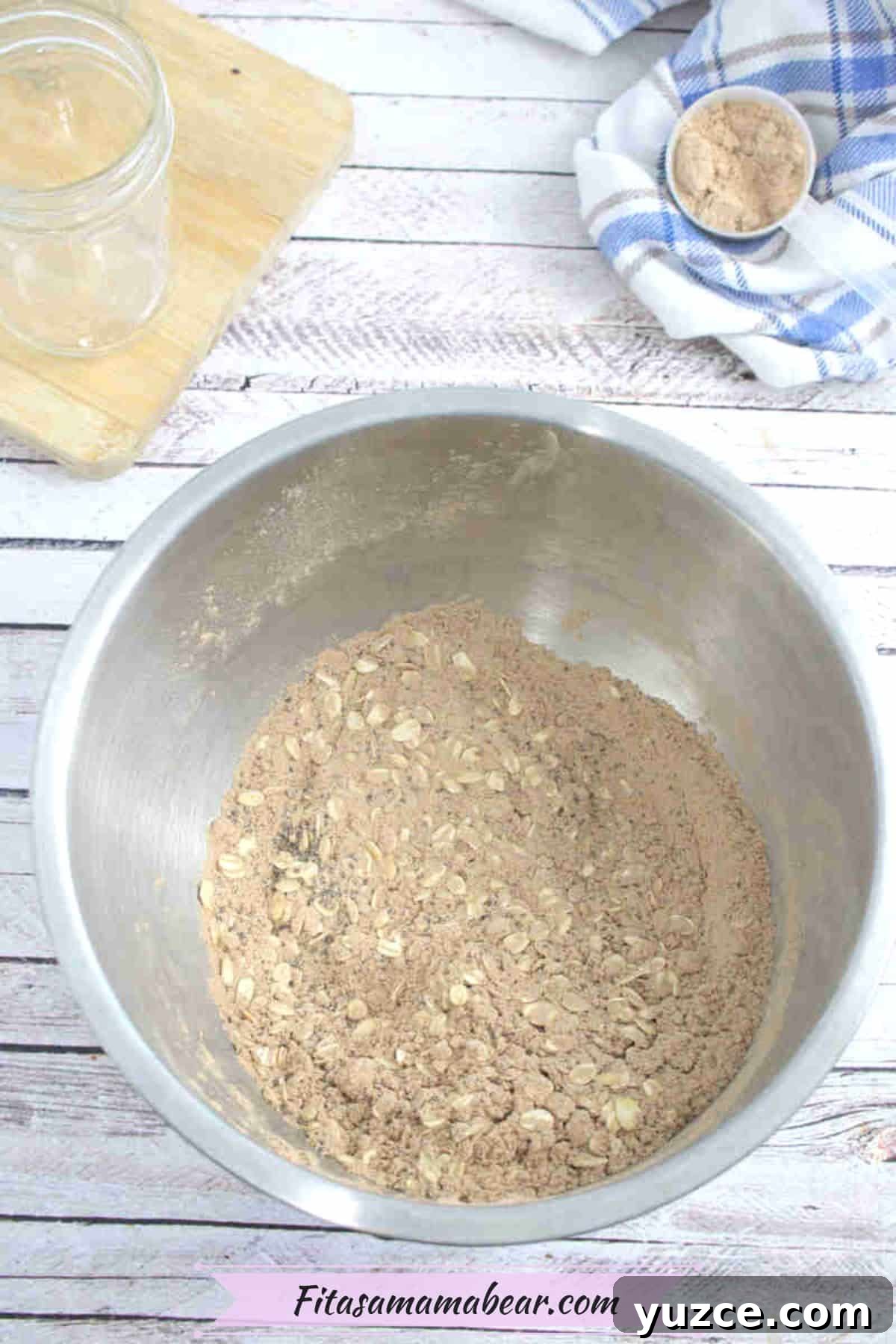Protein-Packed Overnight Oats Recipe for Quick Breakfast 4 Steel bowl with oats, protein powder in it and a cutting board with a mason jar behind it.