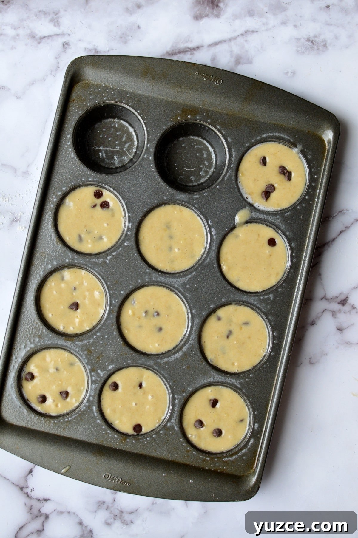a muffin tin filled with batter