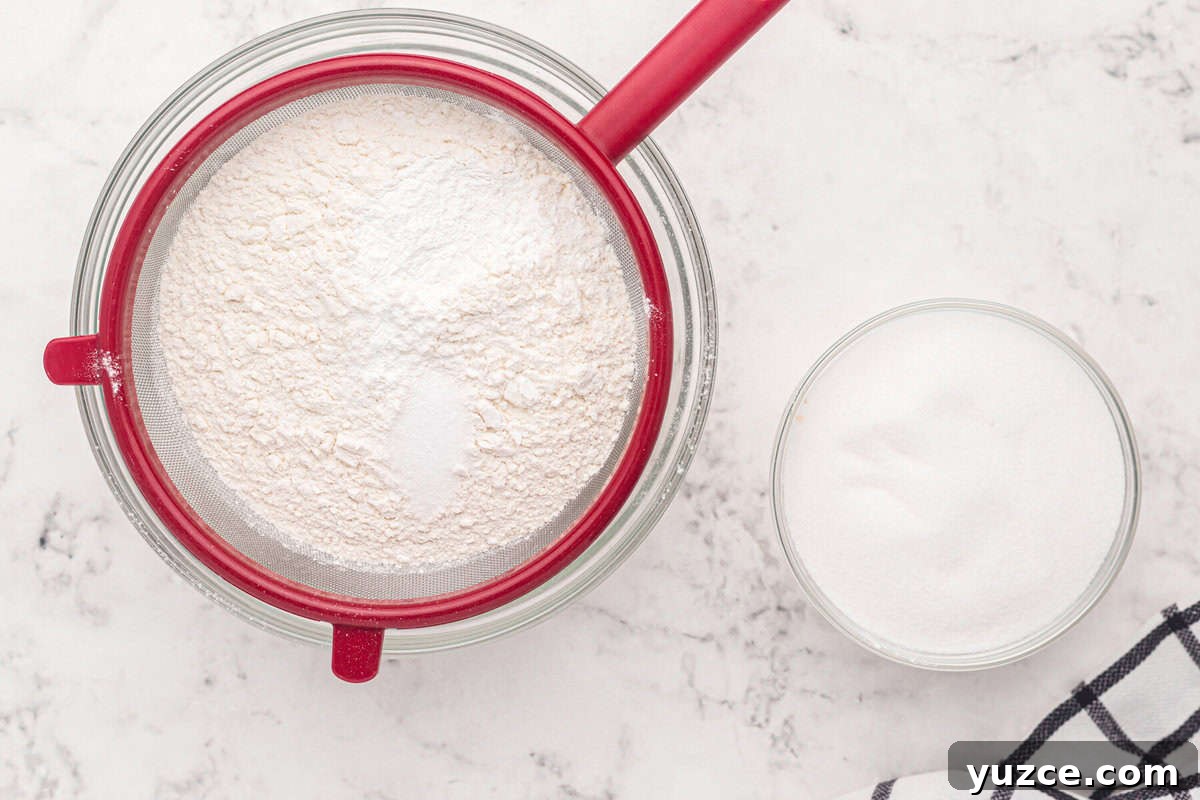 Elegant White Wedding Cake Ideas for Timeless Celebrations 6 sifting flour, sugar, baking powder, and salt into a bowl.