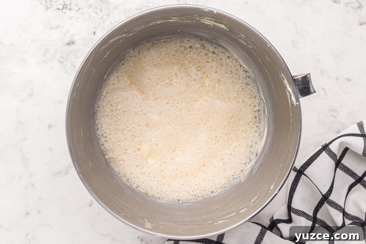 Elegant White Wedding Cake Ideas for Timeless Celebrations 8 foamy egg whites in a stand mixer bowl.