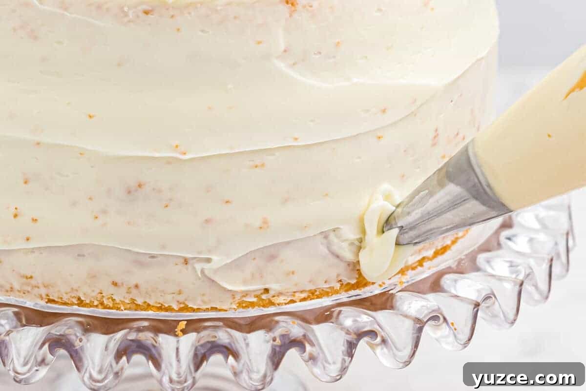 Elegant White Wedding Cake Ideas for Timeless Celebrations 12 piping rosettes around a crumb-coated wedding cake.