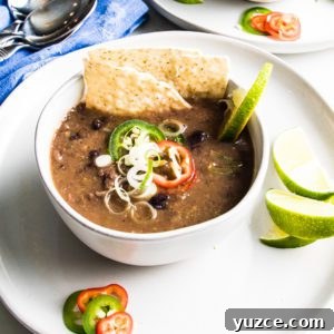 Bowl of black bean soup with toppings