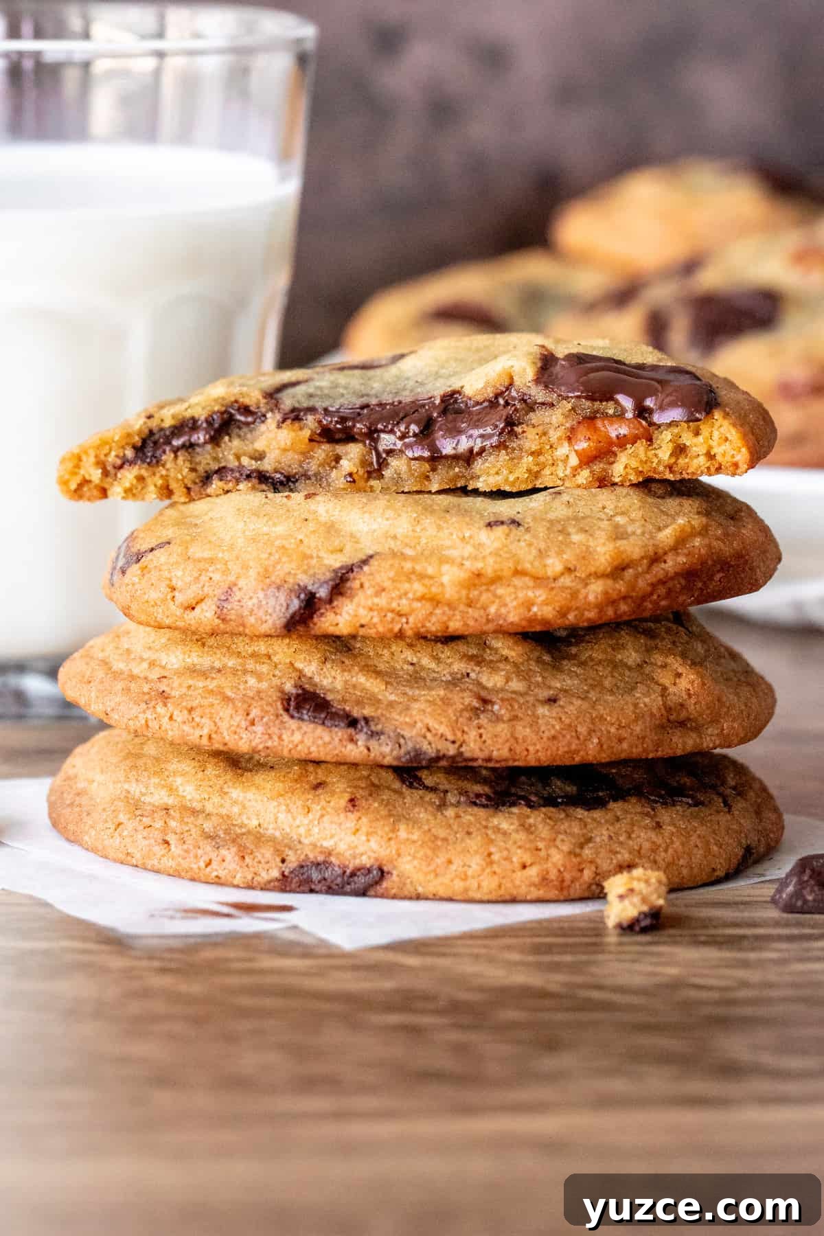 Brown Butter Pecan Chocolate Chip Cookies That Melt in Your Mouth 4 Stack of brown butter pecan chocolate chunk cookies with top cookie broken in half.