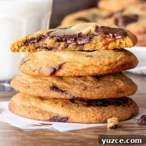 Brown Butter Pecan Chocolate Chip Cookies That Melt in Your Mouth 5 Stack of brown butter pecan chocolate chunk cookies with top cookie broken in half.