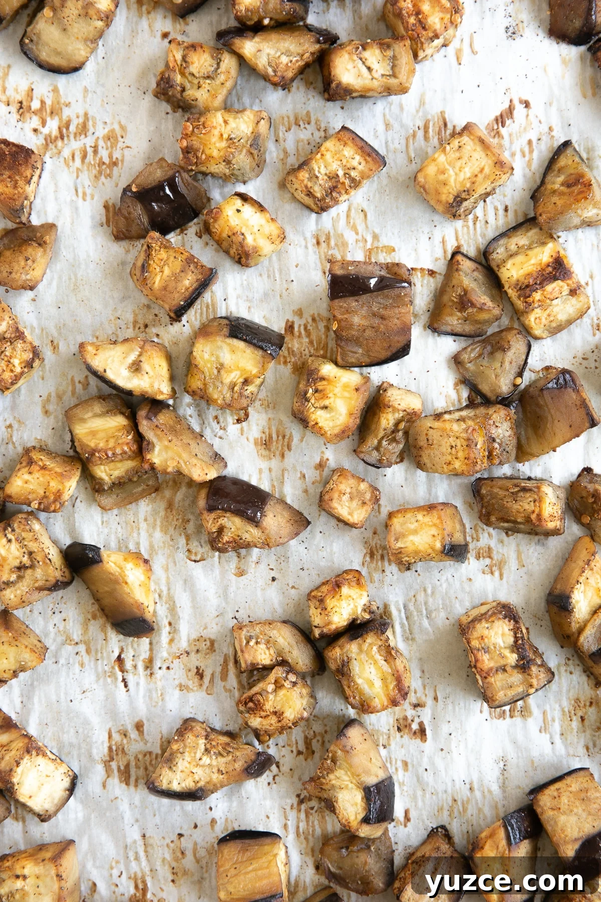 Crispy Oven-Roasted Eggplant with Garlic and Herbs 4 Large baking sheet lined with parchment paper and filled with cubes of oven-roasted eggplant.