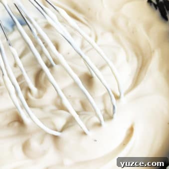 Creamy Garlic White Pizza Sauce Made in One Pot 5 Easy Homemade White Pizza Sauce in Black Pot With Whisk