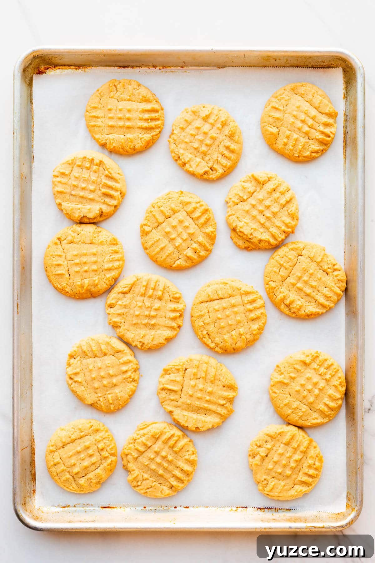 Classic Peanut Butter Cookies Made with Natural Peanut Butter 10 A sheet pan of homemade peanut butter cookies.