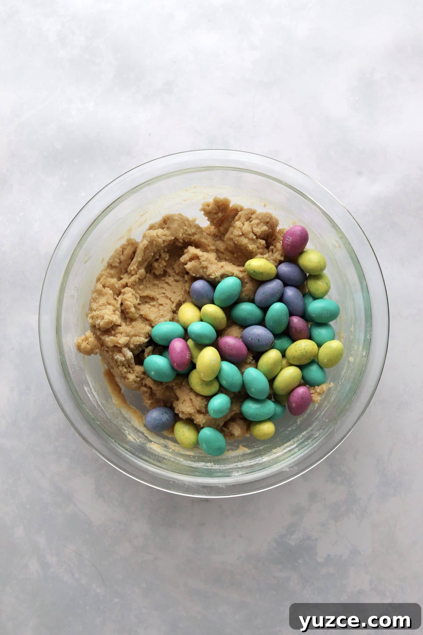 Bowl of blondie dough with Easter mini egg candies.