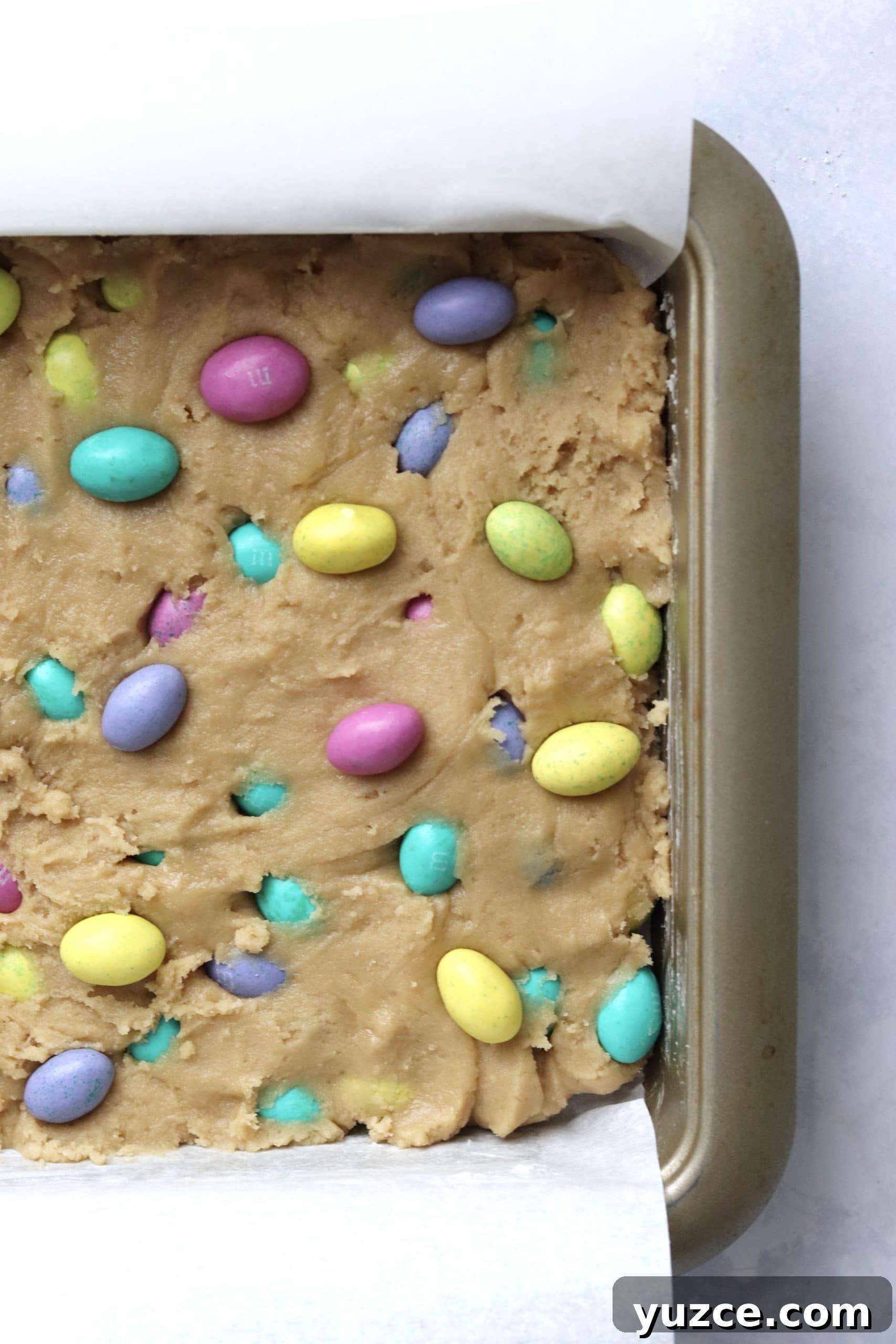 Unbaked Easter mini egg blondies in a baking pan.