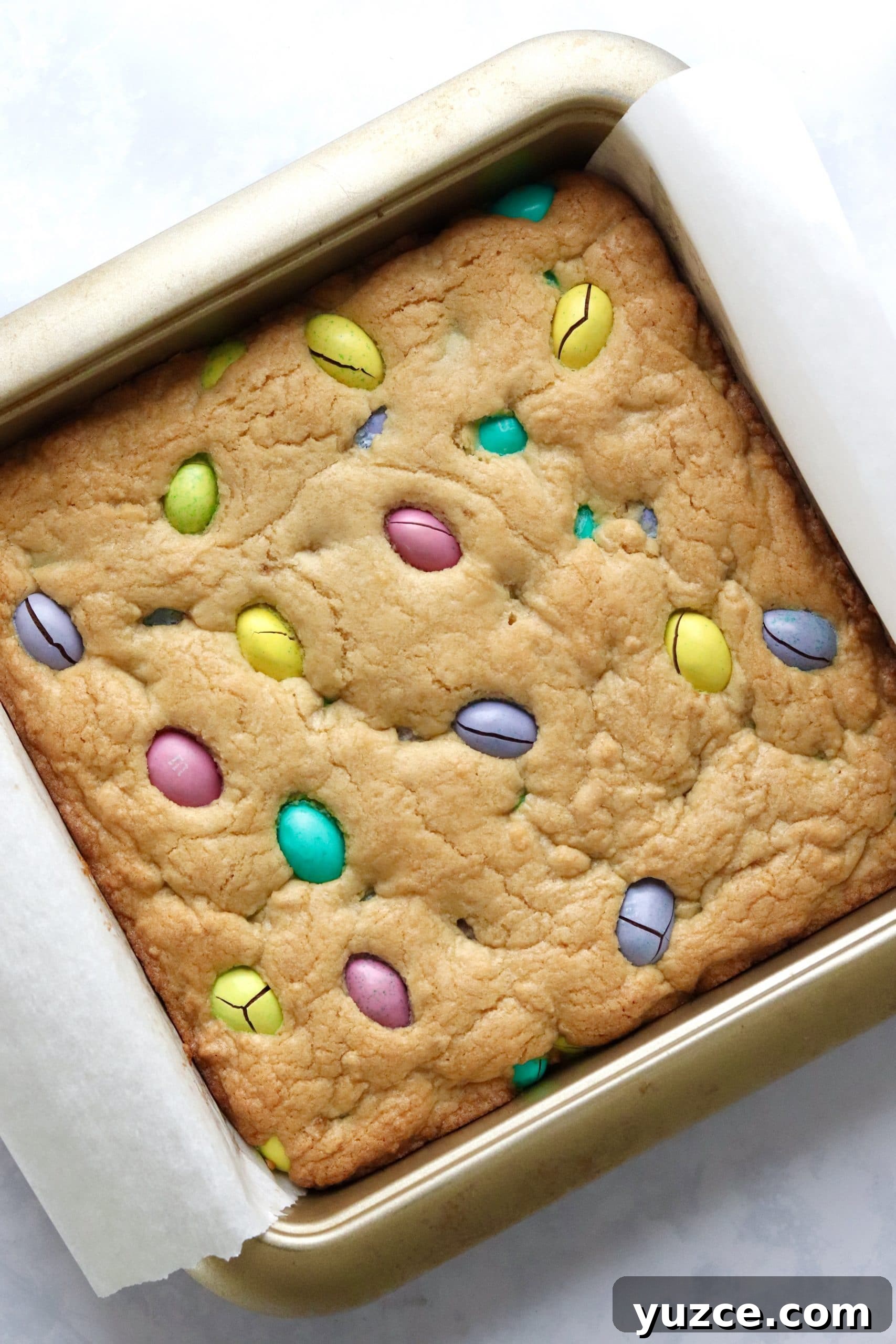 Baked mini egg blondies in a baking pan.