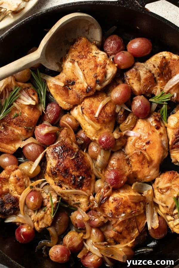 Perfectly Roasted Whole Chicken in a Cast Iron Skillet 12 Chicken thighs in a cast iron skillet with grapes, shallots, and rosemary.