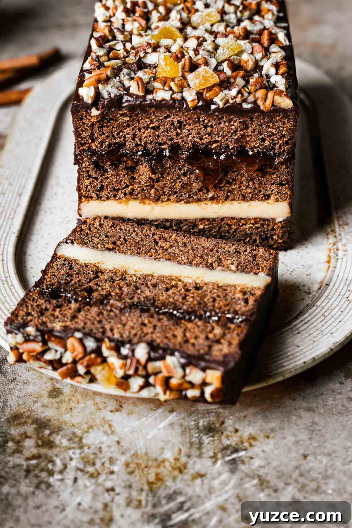Traditional Polish Piernik Gingerbread Cake Recipe 2 An angled view of a chocolate glazed gingerbread cake revealing the layers.