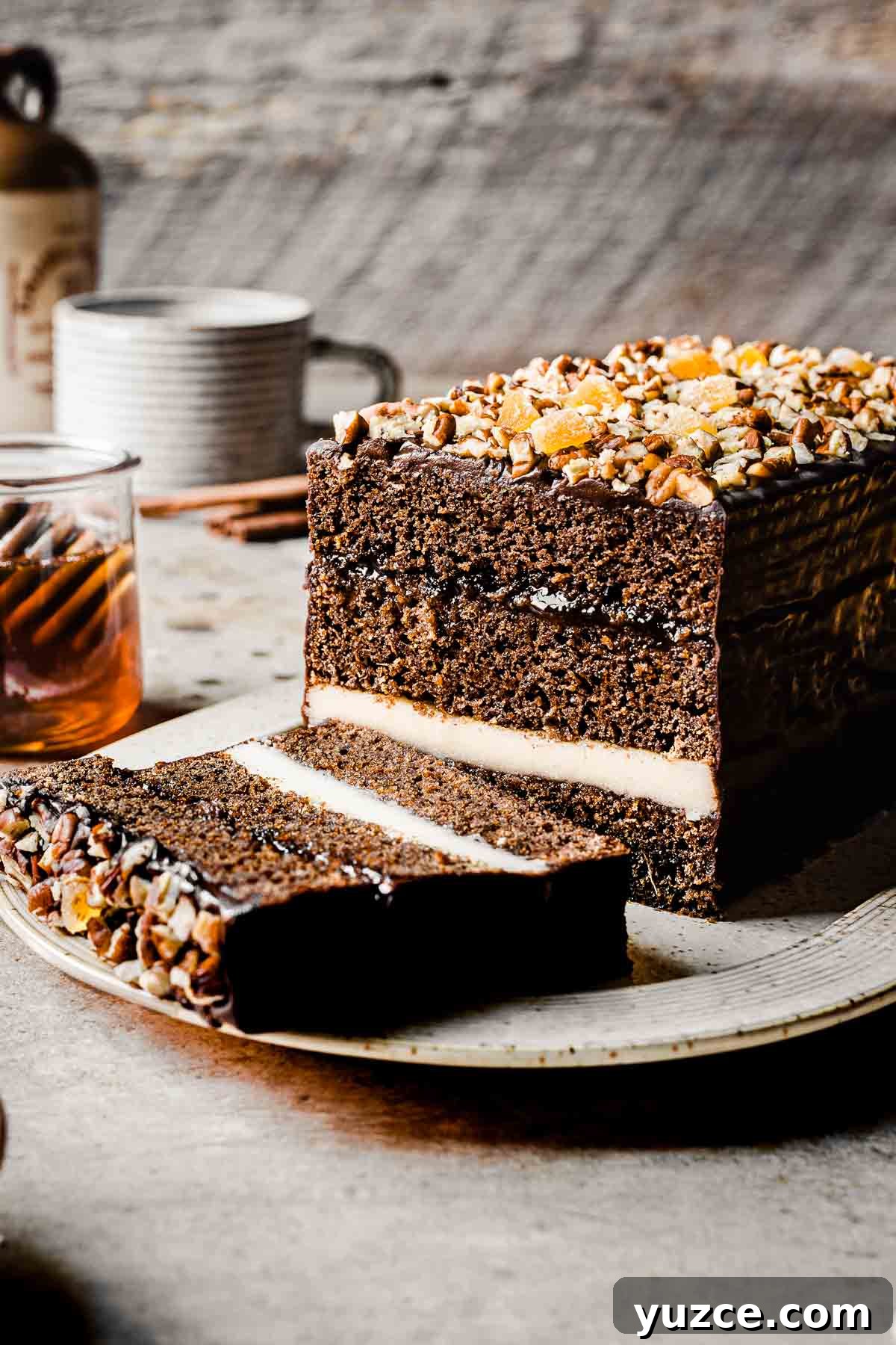 Traditional Polish Piernik Gingerbread Cake Recipe 8 A piernik honey spice cake on a platter with a slice cut off.