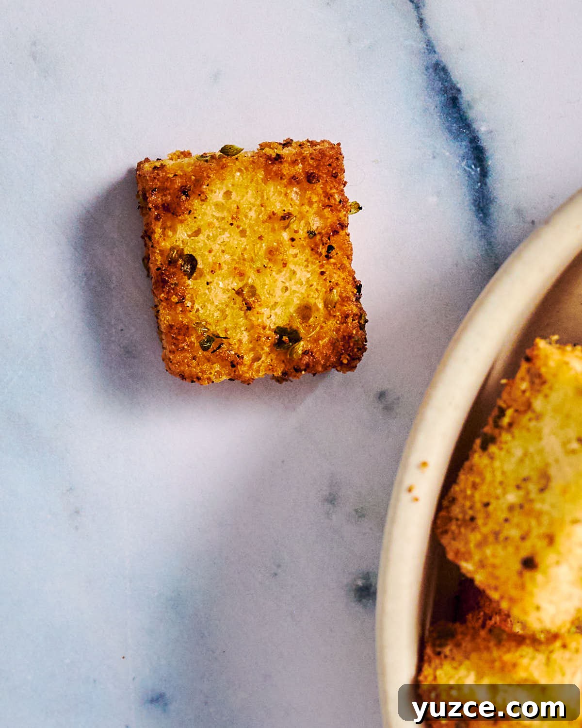 Crispy Air Fryer Crouton Recipe for Salad and Soup 13 Homemade air fryer crouton made with sourdough bread on marble.