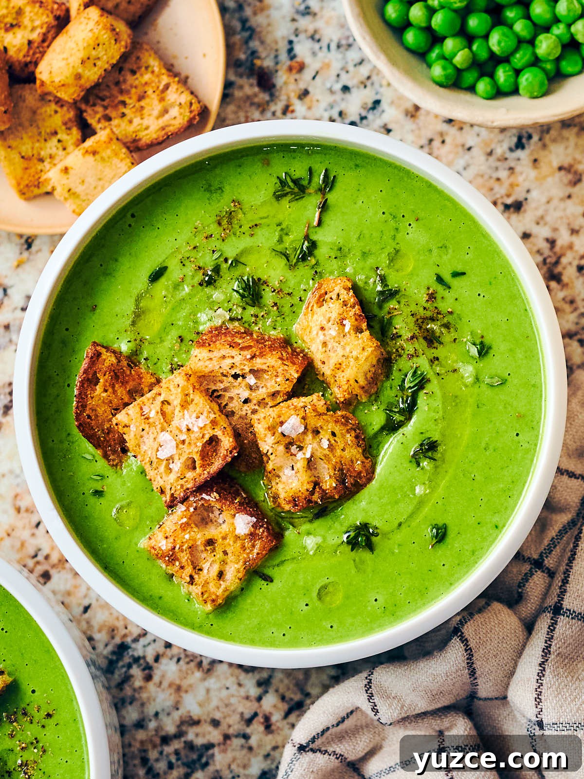 Crispy Air Fryer Crouton Recipe for Salad and Soup 18 Frozen Pea Soup in a bowl topped with the homemade air fryer croutons.