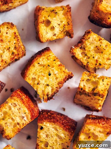 Crispy Air Fryer Crouton Recipe for Salad and Soup 20 Easy air fryer croutons on parchment paper.
