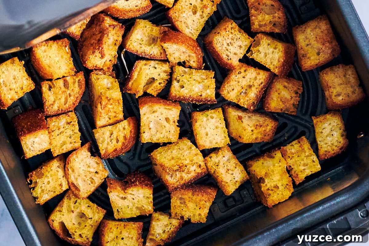 Crispy Air Fryer Crouton Recipe for Salad and Soup 9 Homemade croutons in air fryer basket after baking.