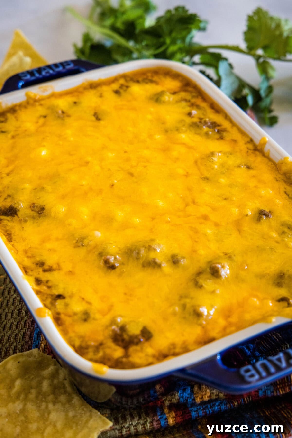 Loaded Beef Enchilada Dip Recipe for Party Appetizers 5 cooked beef enchilada dip in baking dish