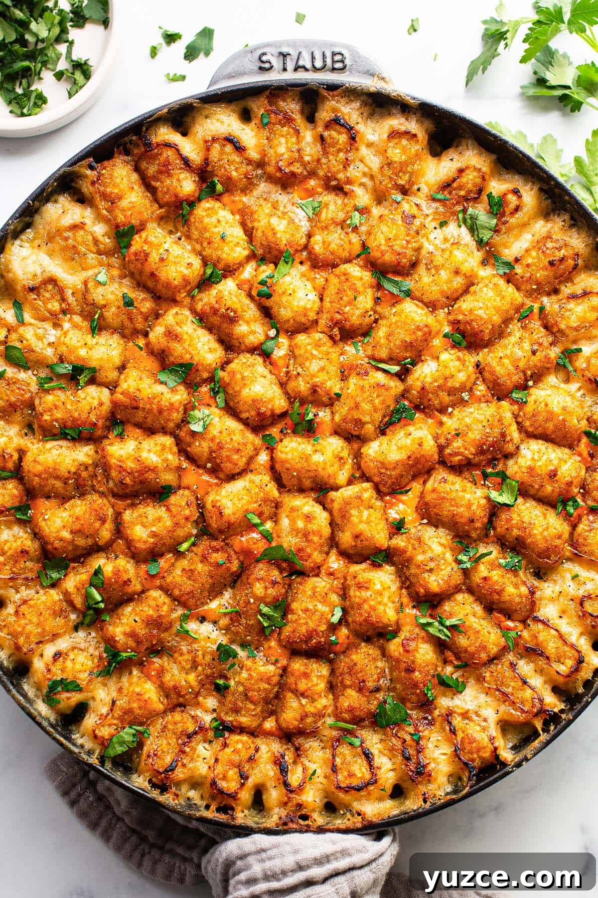 Large cast iron skillet with homemade chicken tater tot casserole. 