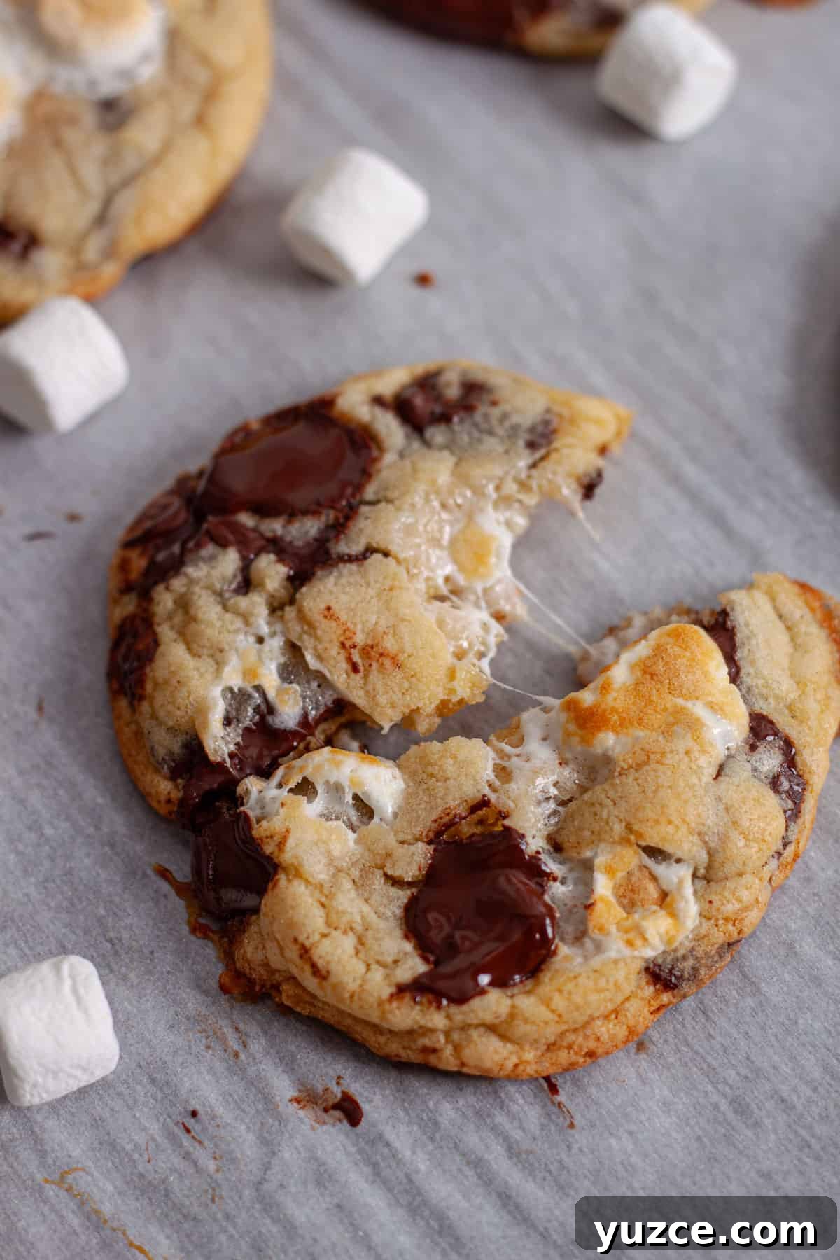 Chewy Chocolate Chip Cookies with Gooey Marshmallow Centers 17 A chocolate chip and marshmallow cookie pulled apart on a baking sheet.