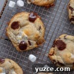 Chocolate chip marshmallow cookies cooling on a wire rack.