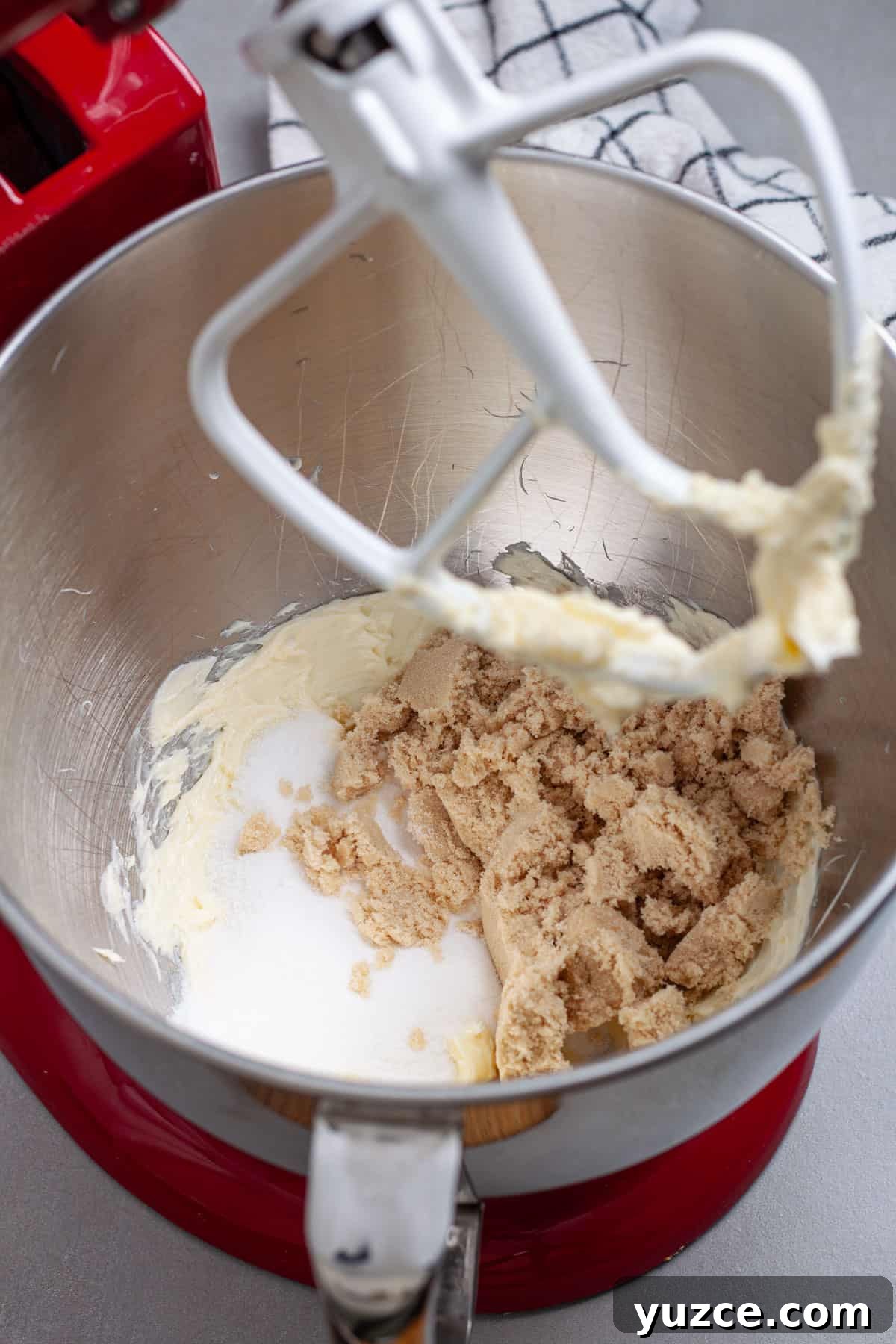 Chewy Chocolate Chip Cookies with Gooey Marshmallow Centers 6 Sugar and brown sugar added to a stand mixer bowl with whipped softened butter.