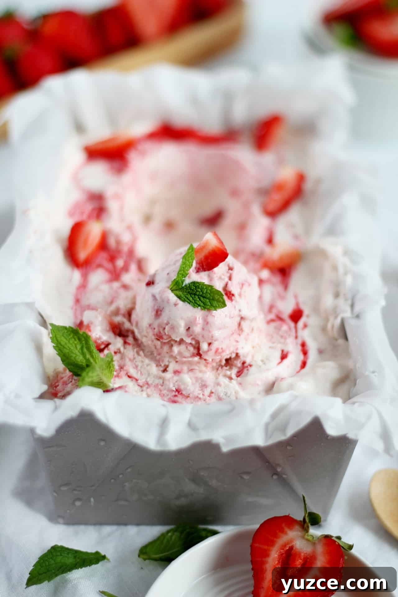 No-Churn Fresh Strawberry Ice Cream Recipe 4 strawberry ice cream in loaf pan decorated with mint leaves