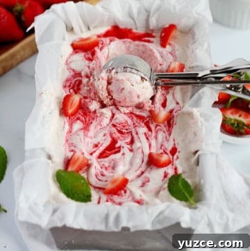 strawberry ice cream in loaf pan with scoop spoon
