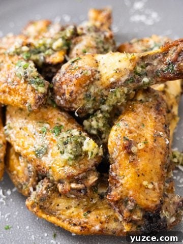 Air fryer garlic parm wings piled neatly on a plate