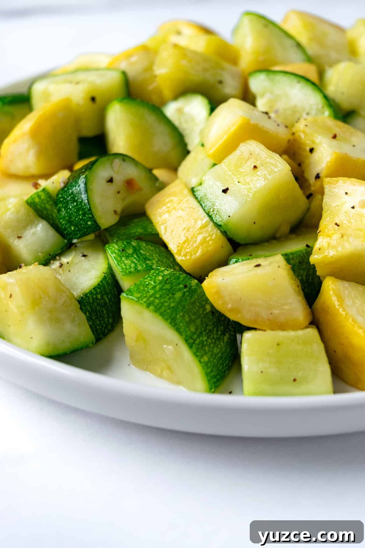 Crispy Air Fryer Zucchini & Summer Squash Recipe 2 Air Fryer Zucchini and Squash on a white serving plate.