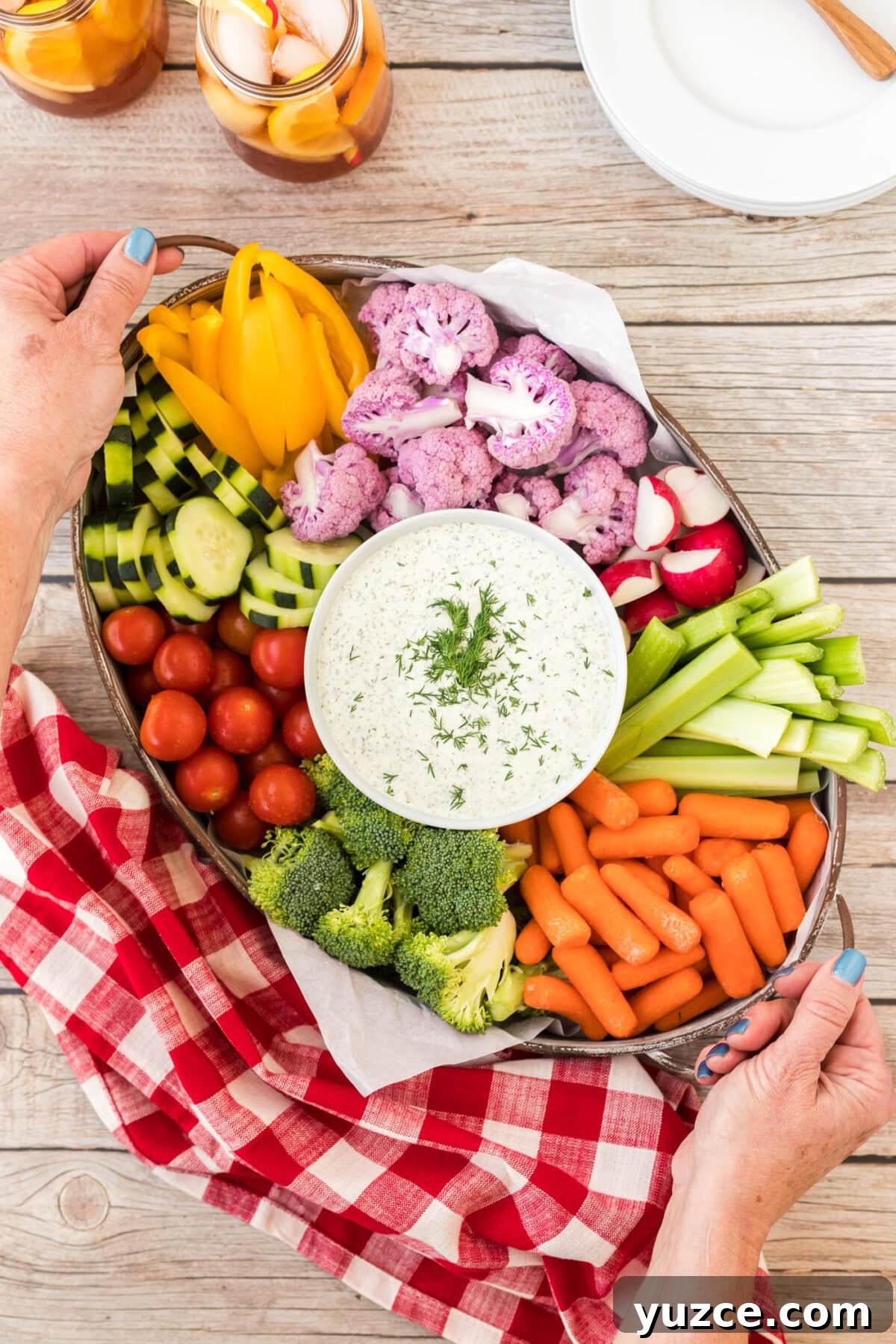 holding a tray of Dill Dip and veggies