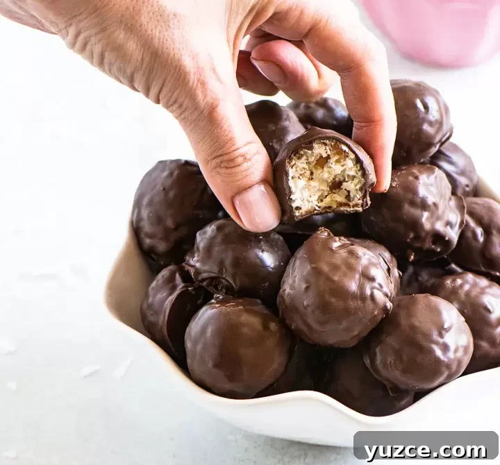 How to Make Homemade Martha Washington Candies: Old-Fashioned Recipe 5 hand lifting a piece of candy out of a bowl of more candies